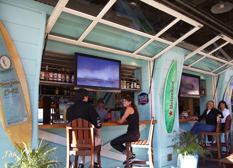 two people sitting at outdoor beach bar